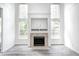 Bright room featuring a stone fireplace, lots of windows, and hardwood-style flooring at 725 Bristle Lake Dr, Brownsburg, IN 46112