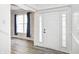 Bright foyer with hardwood-style flooring and white trim and a door with sidelights at 725 Bristle Lake Dr, Brownsburg, IN 46112