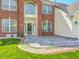 Front exterior of the home with a manicured lawn, brick accents, and front patio area at 725 Bristle Lake Dr, Brownsburg, IN 46112