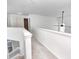 An upstairs hallway featuring carpet, a staircase, and natural light at 725 Bristle Lake Dr, Brownsburg, IN 46112
