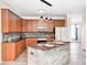 An expansive kitchen island with stone accents, granite countertops, and wood cabinetry at 725 Bristle Lake Dr, Brownsburg, IN 46112