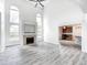 Bright open living room featuring hardwood floors, a fireplace, and plenty of natural light at 725 Bristle Lake Dr, Brownsburg, IN 46112