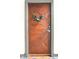 Stylish wooden unit door with wreath and number, creating an inviting and personalized entry to the home at 735 Lexington Ave # 23, Indianapolis, IN 46203