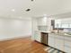 Clean white kitchen with stainless steel appliances, ample counter space, and hardwood floors, a chef's delight at 735 Lexington Ave # 23, Indianapolis, IN 46203