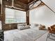 A spacious living area with exposed brick, large windows, and comfortable seating, creating a cozy atmosphere at 735 Lexington Ave # 23, Indianapolis, IN 46203