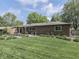 Brick home's backyard with landscaping, inviting outdoor space, and well-maintained lawn at 748 Woodcreek Ct, Greenwood, IN 46142