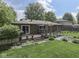 Backyard view of the home with wooden deck, landscaping, and lush green lawn at 748 Woodcreek Ct, Greenwood, IN 46142