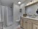 Bright bathroom with a shiplap wall, a white walk-in shower, and a rustic wood vanity with a framed mirror at 748 Woodcreek Ct, Greenwood, IN 46142