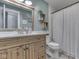 Bright bathroom featuring a wood vanity with marble counters and a shower with a white curtain at 748 Woodcreek Ct, Greenwood, IN 46142