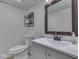 Basement bathroom features a toilet, sink, vanity, and a clean, modern design at 748 Woodcreek Ct, Greenwood, IN 46142