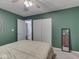 Green-walled bedroom with sliding closet doors and an en-suite bathroom at 748 Woodcreek Ct, Greenwood, IN 46142