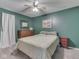 Green-walled bedroom featuring a comfortable bed, dresser, and a ceiling fan for added comfort at 748 Woodcreek Ct, Greenwood, IN 46142