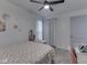 Well-lit bedroom featuring a floral wall design, study desk, and a ceiling fan for added comfort at 748 Woodcreek Ct, Greenwood, IN 46142