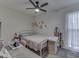 Bright bedroom featuring a floral wall design, study desk, and a ceiling fan for added comfort at 748 Woodcreek Ct, Greenwood, IN 46142