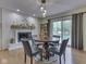 Dining area with fireplace and sliding glass doors, and wood floors at 748 Woodcreek Ct, Greenwood, IN 46142