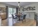Open dining room with a wood table and chairs set, with sliding doors to the backyard at 748 Woodcreek Ct, Greenwood, IN 46142