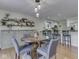 Bright dining room featuring a round table set and hardwood floors with open access to kitchen at 748 Woodcreek Ct, Greenwood, IN 46142