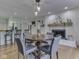 Dining area with a round table set and hardwood floors with open access to kitchen and fireplace at 748 Woodcreek Ct, Greenwood, IN 46142
