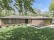Charming single-story brick home with a well-manicured lawn and mature trees offering great curb appeal at 748 Woodcreek Ct, Greenwood, IN 46142