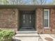 Close-up of a home's front entrance featuring a stately double door and brick facade at 748 Woodcreek Ct, Greenwood, IN 46142