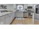 Stylish kitchen featuring stainless steel appliances, wood floors, and white cabinets at 748 Woodcreek Ct, Greenwood, IN 46142