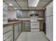 Basement kitchen featuring classic cabinetry, appliances, and functional layout at 748 Woodcreek Ct, Greenwood, IN 46142