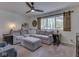 Cozy living room featuring a sectional sofa, a window with barn door accents, and soft carpeting at 748 Woodcreek Ct, Greenwood, IN 46142