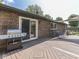 A wooden patio with a grill, seating, and sliding doors, perfect for outdoor entertaining and relaxation at 748 Woodcreek Ct, Greenwood, IN 46142