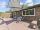 Backyard patio area with a sunshade, outdoor furniture, grill, and brick exterior at 748 Woodcreek Ct, Greenwood, IN 46142