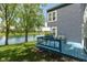 Waterfront home with a blue deck overlooking a serene lake and lush greenery, ideal for relaxation at 7608 Harbour, Indianapolis, IN 46240