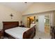 Bright bedroom with a vaulted ceiling, wooden sleigh bed, and ensuite bathroom, offering a private retreat at 7608 Harbour, Indianapolis, IN 46240