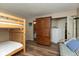 Cozy bedroom featuring bunk beds, an armoire, and a sitting area, creating a versatile space at 7608 Harbour, Indianapolis, IN 46240