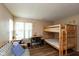 Bedroom with bunk beds, a study area, and a window letting in natural light, perfect for  at 7608 Harbour, Indianapolis, IN 46240