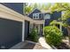Charming two-story home with a front walkway and attached garage on a sunny day at 7608 Harbour, Indianapolis, IN 46240