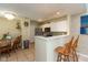Eat-in kitchen features white cabinets, tile backsplash, stainless appliances, and modern lighting at 7608 Harbour, Indianapolis, IN 46240