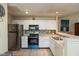 Bright kitchen with white cabinets, stainless steel appliances, and a breakfast bar at 7608 Harbour, Indianapolis, IN 46240