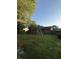 Spacious backyard with mature trees and lush green lawn, featuring a classic wooden swing set at 7627 Venetian Way, Indianapolis, IN 46217