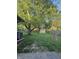 Large backyard featuring a shed, lush lawn, mature trees, and space for outdoor activities at 7627 Venetian Way, Indianapolis, IN 46217