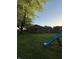 Expansive backyard featuring mature trees, green lawn, and a slide for outdoor fun at 7627 Venetian Way, Indianapolis, IN 46217