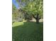 Lush backyard with mature trees and play equipment, perfect for outdoor fun at 7627 Venetian Way, Indianapolis, IN 46217