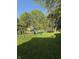 Spacious backyard featuring a swing set and trampoline, ideal for Gathering activities at 7627 Venetian Way, Indianapolis, IN 46217