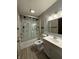 Bathroom featuring tiled walls, vinyl flooring, a glass shower, and white vanity at 7627 Venetian Way, Indianapolis, IN 46217