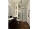Bathroom featuring dark vanity, built in shelves and sliding shower door at 7627 Venetian Way, Indianapolis, IN 46217