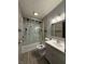 Bathroom featuring tiled walls, vinyl flooring, a glass shower, and white vanity at 7627 Venetian Way, Indianapolis, IN 46217