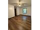 Inviting bedroom with wood-look floors, a ceiling fan, natural light, and neutral walls at 7627 Venetian Way, Indianapolis, IN 46217