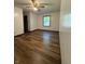 Bedroom featuring hardwood floors, white walls, a ceiling fan, and a window at 7627 Venetian Way, Indianapolis, IN 46217
