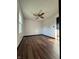 Inviting bedroom featuring wood-look flooring, a ceiling fan, and ample natural light at 7627 Venetian Way, Indianapolis, IN 46217