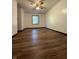 Bedroom featuring hardwood floors, white walls, a ceiling fan, and a window at 7627 Venetian Way, Indianapolis, IN 46217