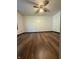 Bedroom featuring hardwood floors, white walls, and a ceiling fan with light fixture at 7627 Venetian Way, Indianapolis, IN 46217