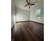 Bedroom with hardwood floors, white walls, ceiling fan, and a window with view at 7627 Venetian Way, Indianapolis, IN 46217